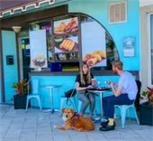 couple dining on Beach Street with their dog